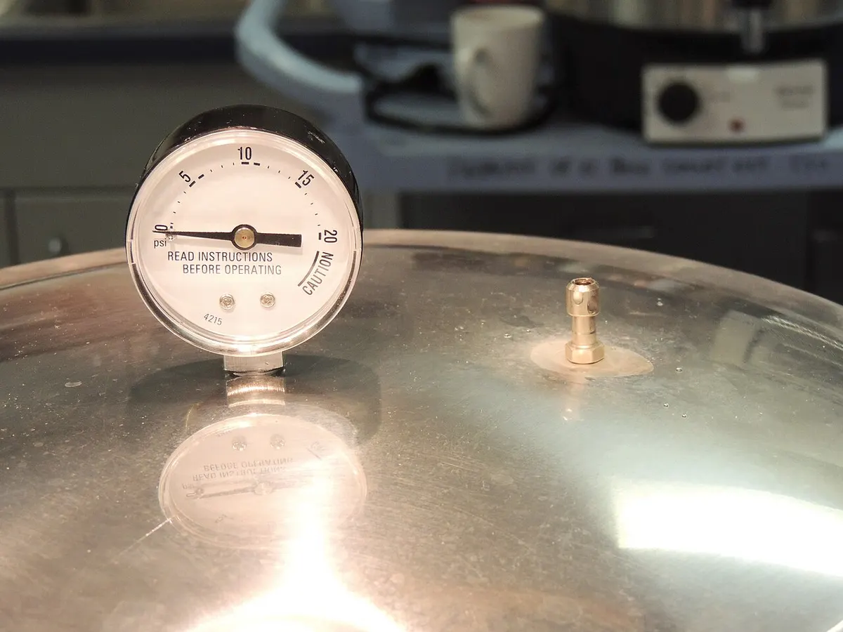 The dial pressure gauge on a stovetop pressure canner lid